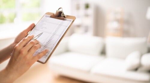Person Reviewing Appraisal Checklist on Clipboard
