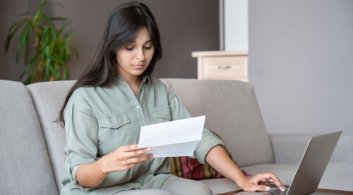 Woman Reviewing Her Bill with Her Laptop