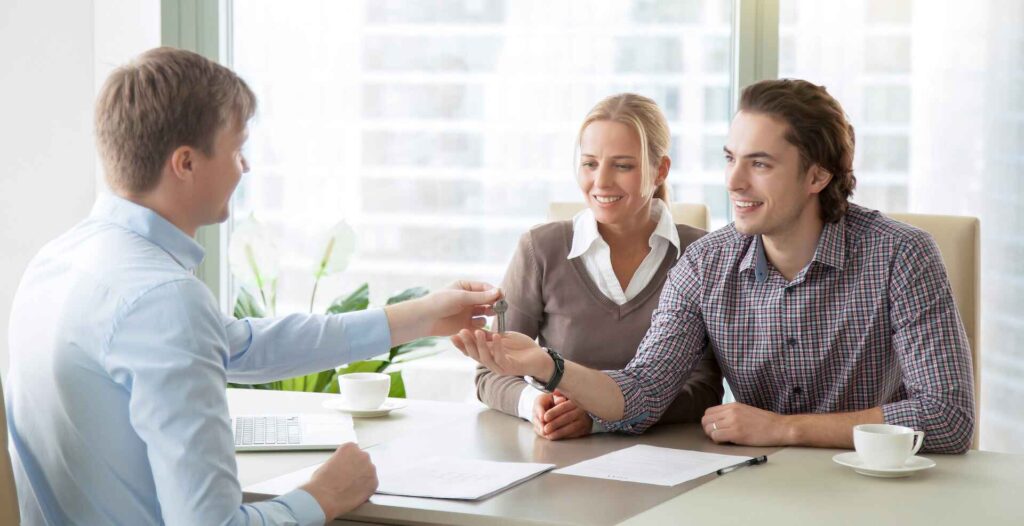 Couple Meeting Lender at Closing and Getting Their Keys